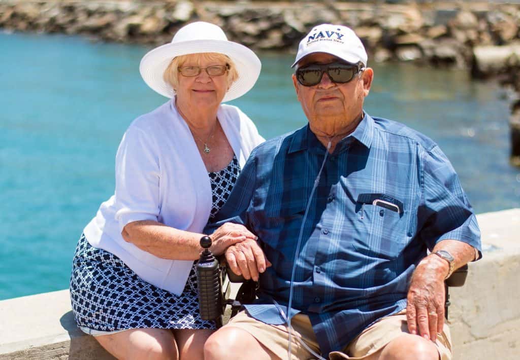 Older couple sitting by water