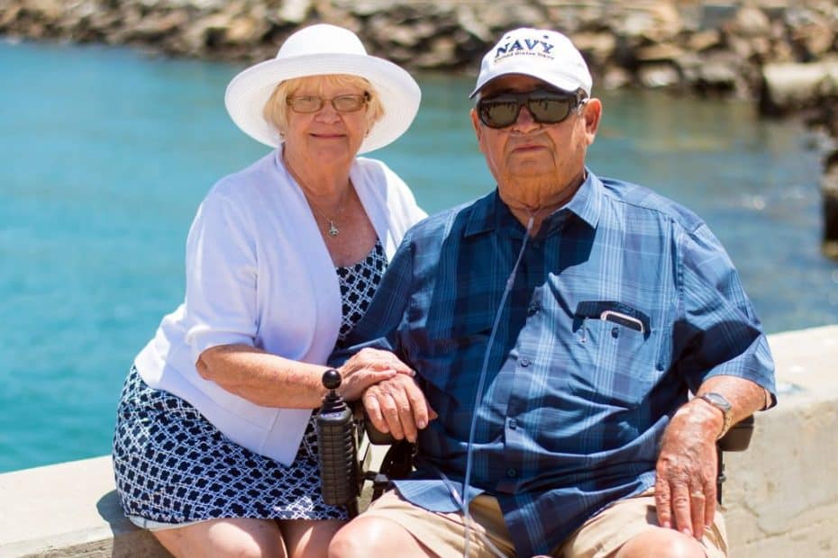 Older couple sitting by water