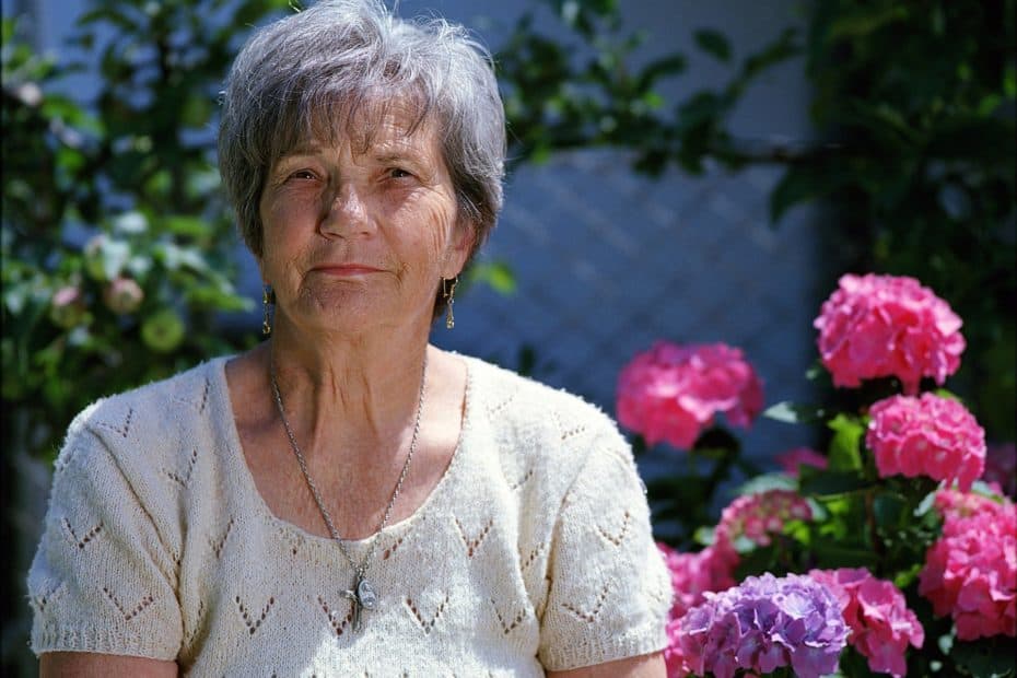 older woman with flowers bundled payments