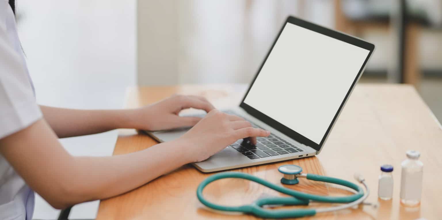 doctor using a laptop computer on a desk