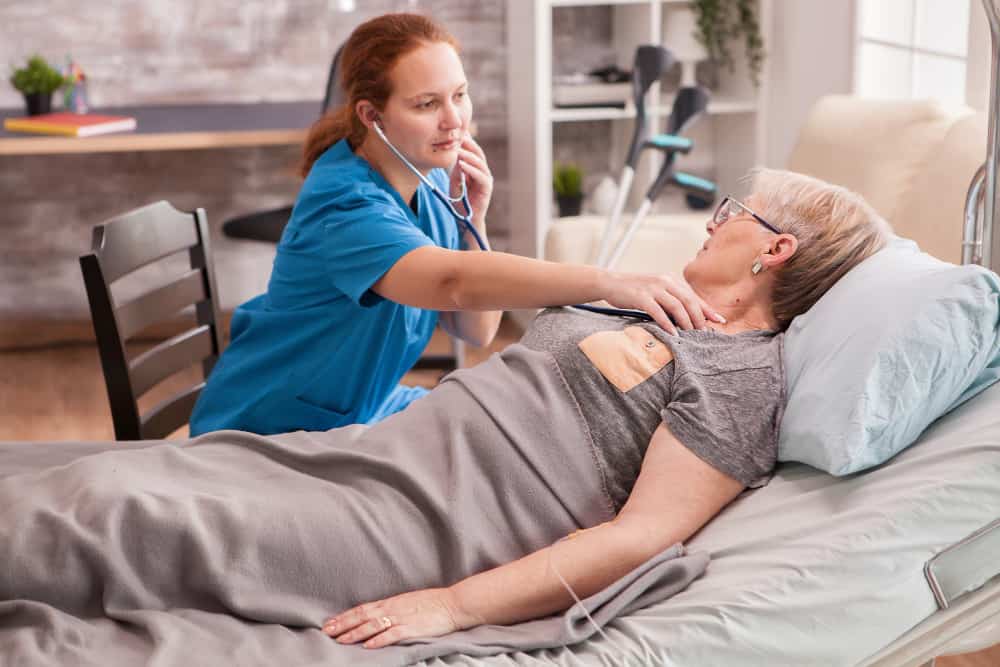 female-doctor-using-stethoscope-check-old-woman-heart-nursing-home